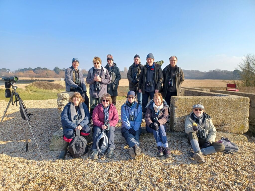 The group having a rest during a visit to the coast