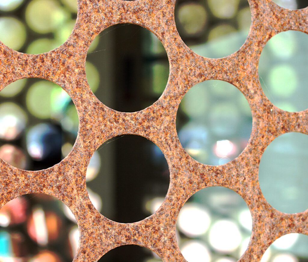 Image through a steel plate with a colored background